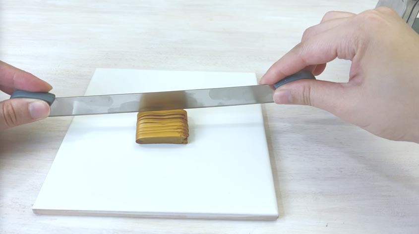 using blade to slice gold clay